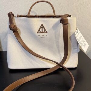 Loungefly Desthly Hallows Edlers bag. Linen texture with metal handle and wand.